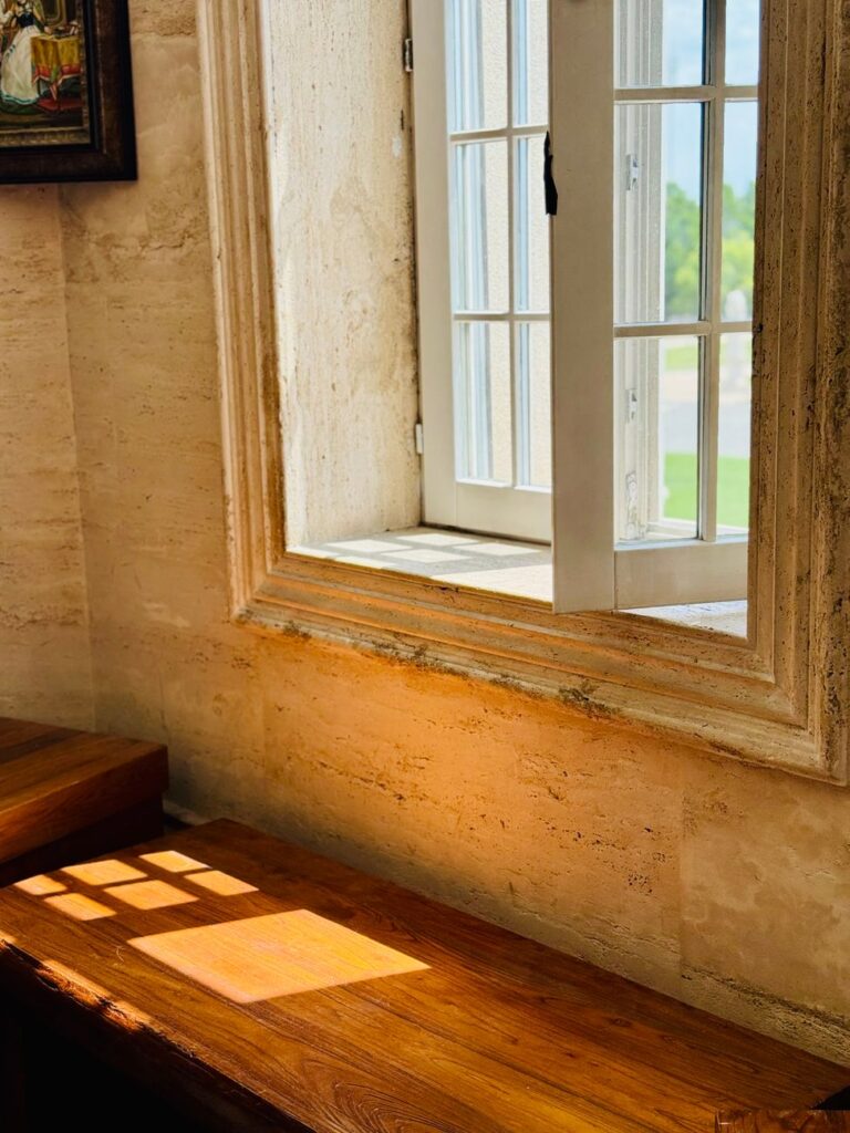 sunlit open window frame in rustic interior