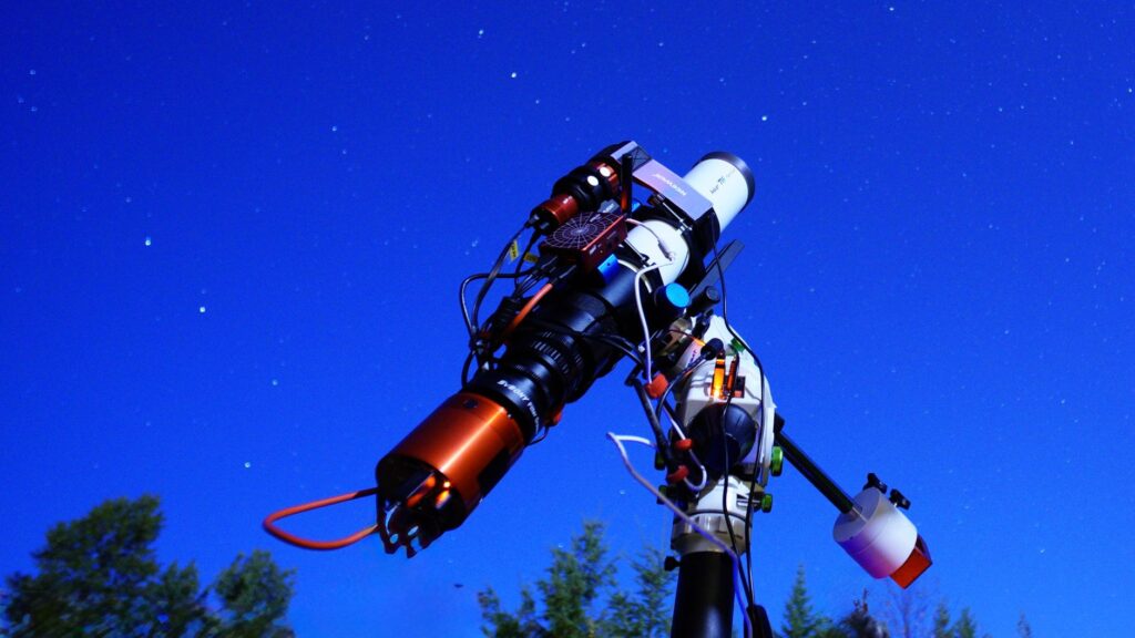 astronomical telescope under starry night sky